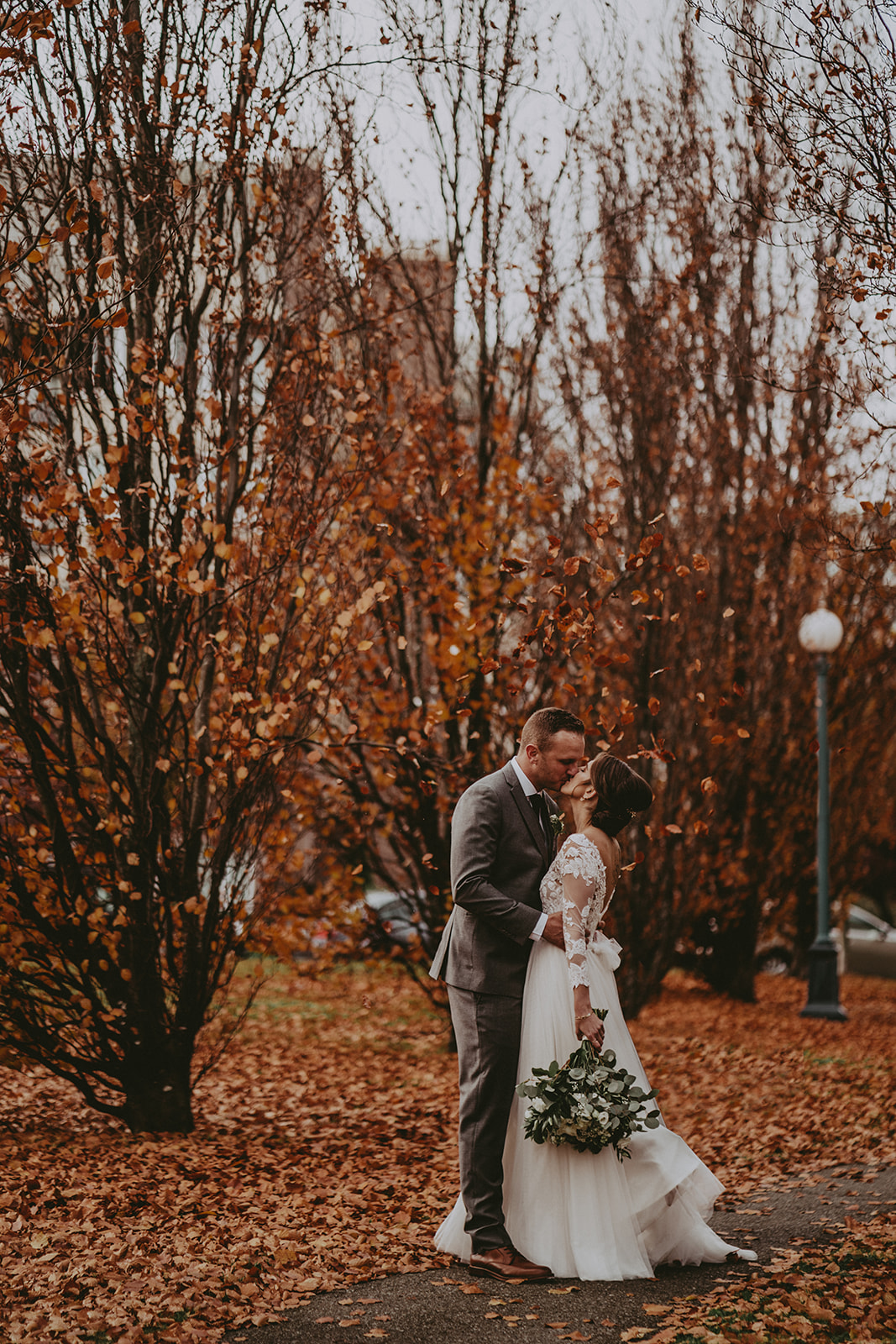 bride and groom falling leaves
