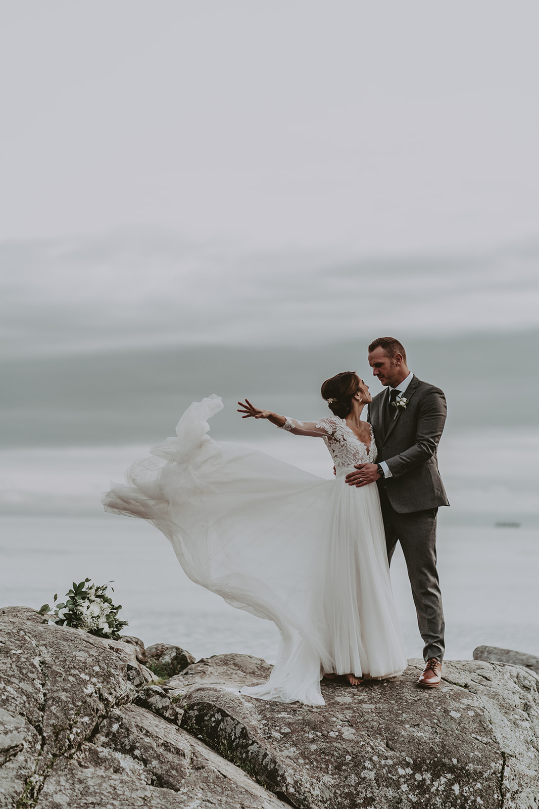 bride and groom dress in wind