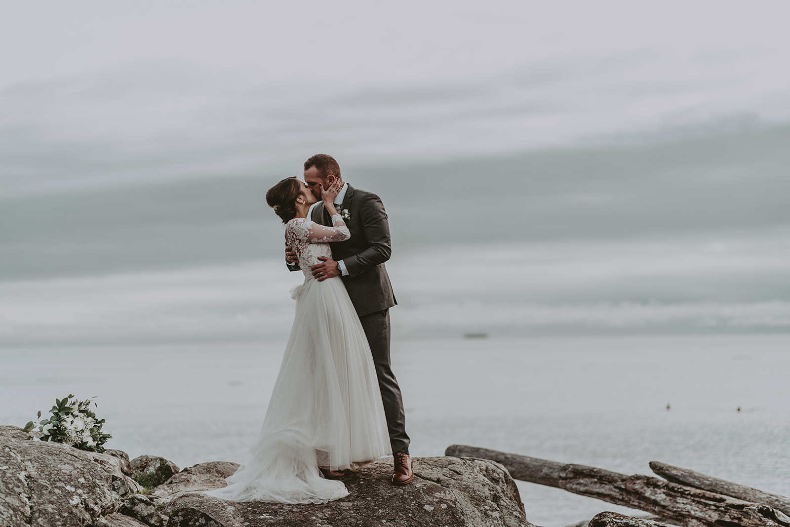 bride and groom by the ocean