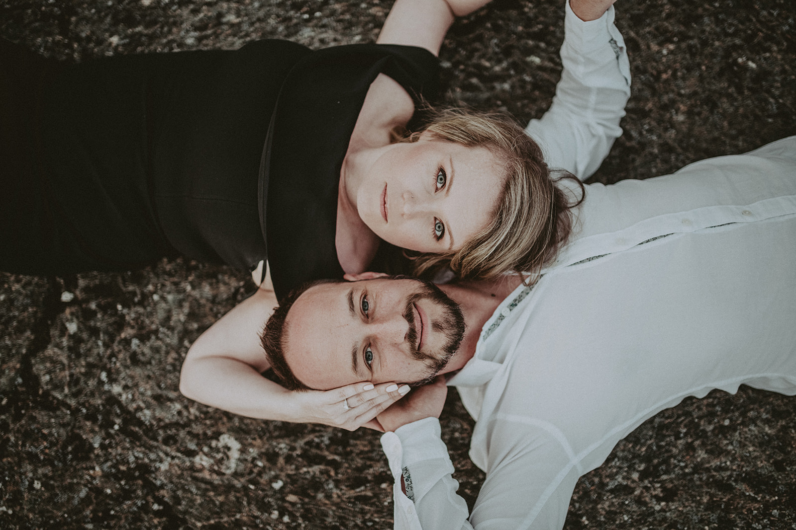 Victoria-BC-wedding-engagement-photography. Couple lying looking up, in love. Black and white outfits.